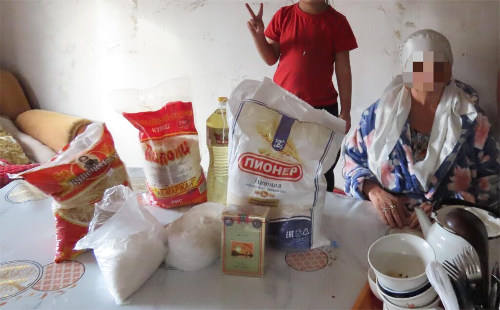 Food packages being distributed to a woman and child.